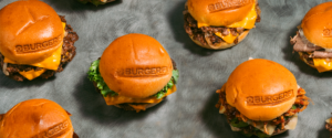 An assortment of delicious burgers near me on a tray, ready to enjoy.