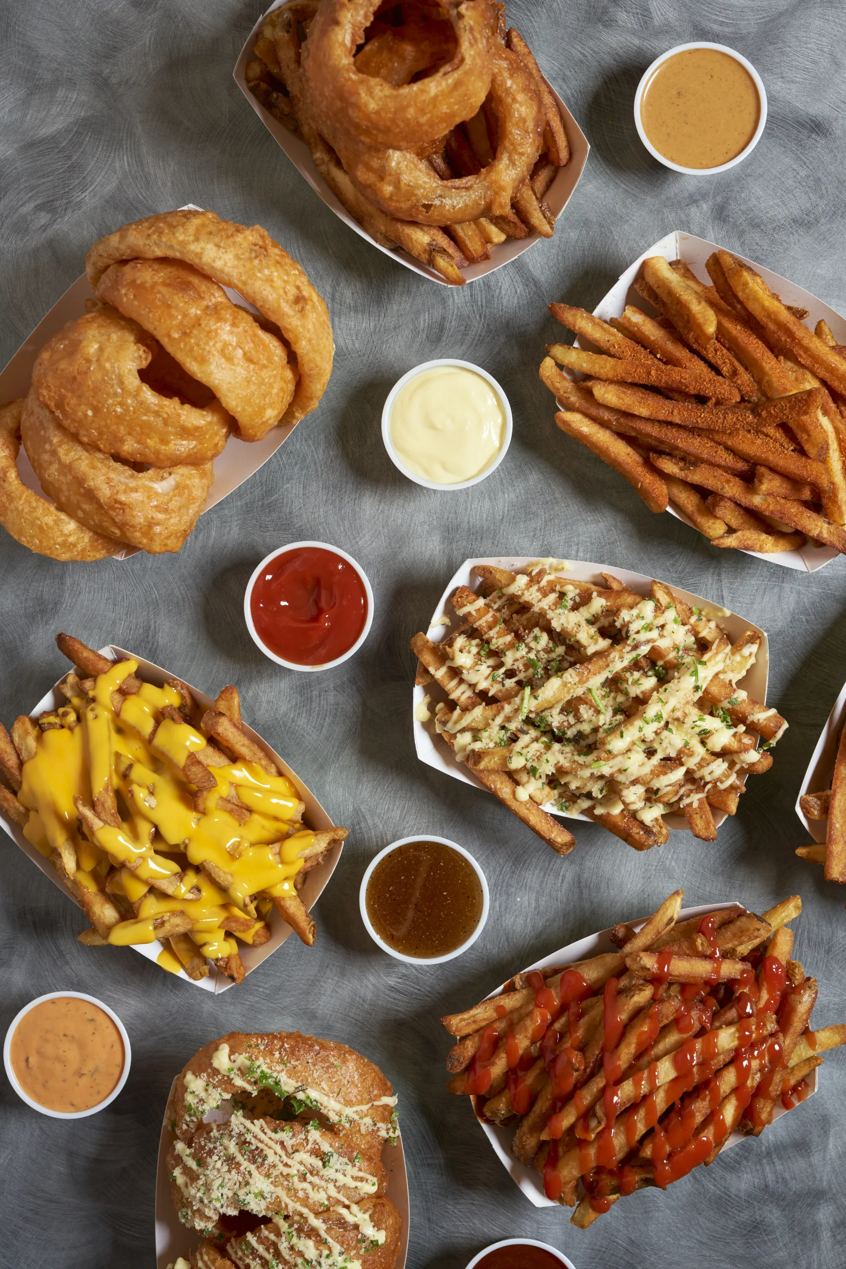 This image is a fry lover's dream! With so many different types of fries and dipping sauces, the possibilities for sauce pairings are endless.