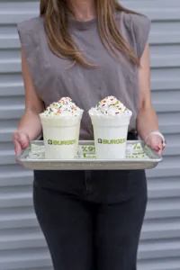 A tray with two BurgerFi custard shakes.