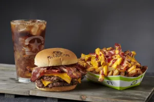 A meal at BurgerFi with a signature burger with the best beef, loaded fries, and a glass of soda. 