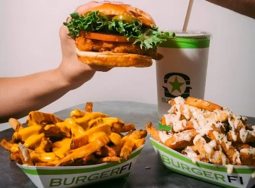 A delicious spread of burgers and fries, featuring a juicy burger, loaded fries, and a refreshing beverage.