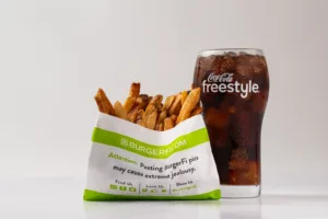 Classic fries served with a refreshing Coca-Cola, showcasing a timeless pairing of drinks and snacks for a satisfying treat.