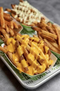 A variety of delicious french fry sides, each with a different topping and flavor.