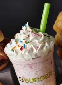 A close of BurgerFi’s frozen custard shakes with rainbow sprinkles on top.