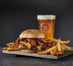  BurgerFi beer, burger and fried placed on a wooden board. 