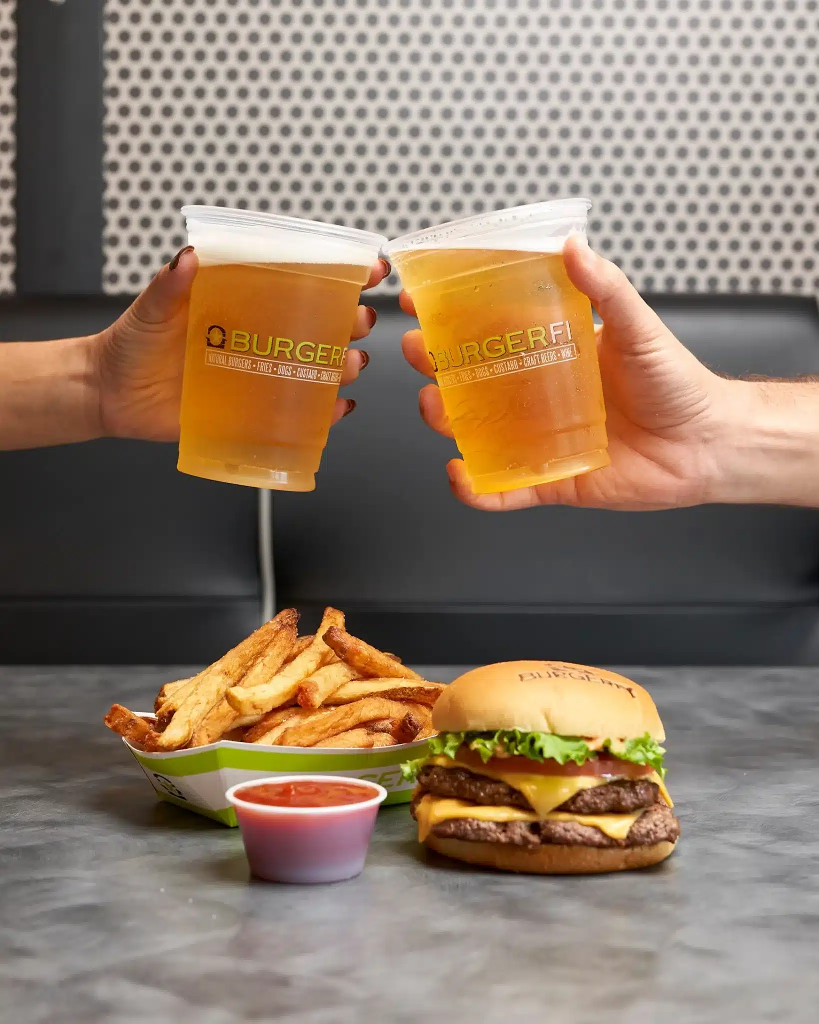 Fried, burger and beers from BurgerFi enjoyed by two.