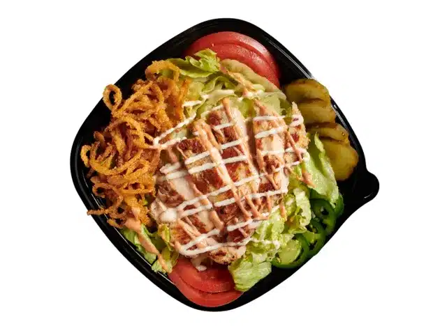 A BurgerFi chicken tender Bowl served in a black bowl.